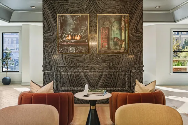 a lobby with furniture and a chandelier