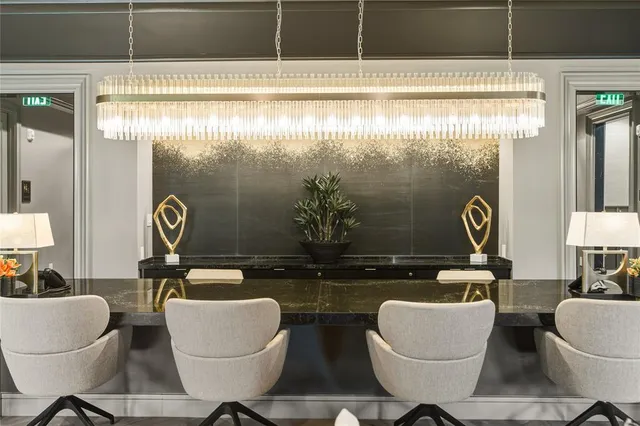 a living room with furniture and large windows