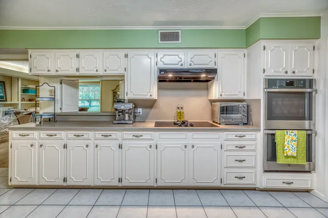 a kitchen with stainless steel appliances granite countertop a sink and cabinets