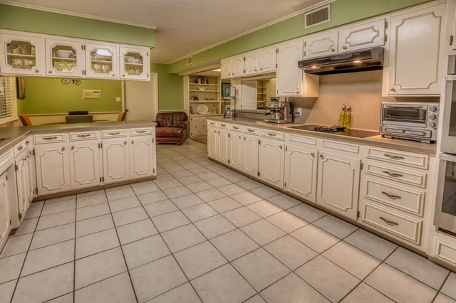 a kitchen with stainless steel appliances granite countertop a sink and cabinets