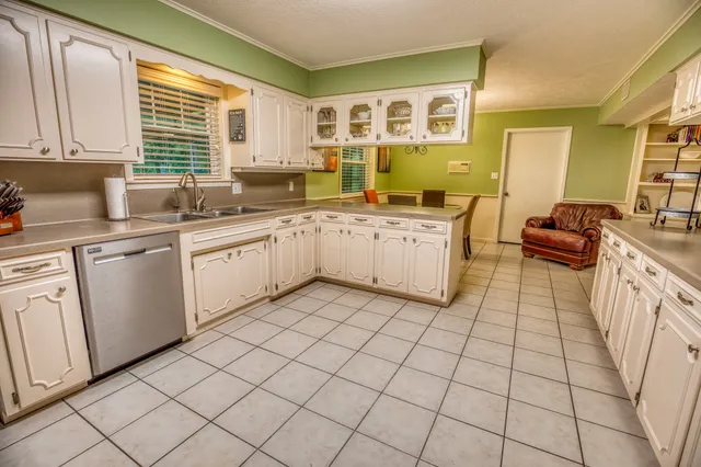 a kitchen with stainless steel appliances granite countertop a sink and cabinets