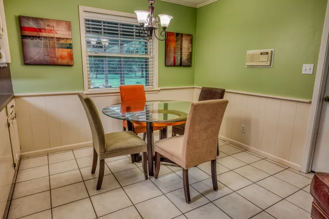a view of a dining room with furniture and a window