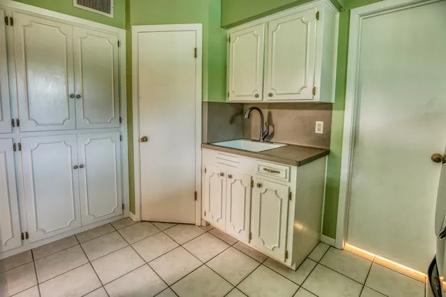 a view of a kitchen with white cabinets