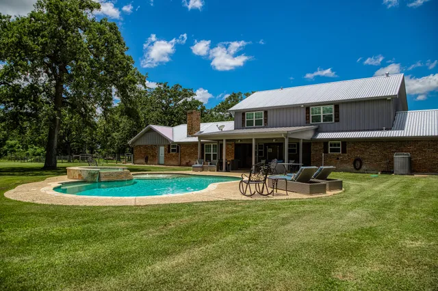a view of a house with a yard porch and sitting area