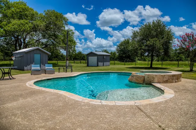 a view of a swimming pool with a yard