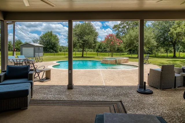 a view of a swimming pool with a patio