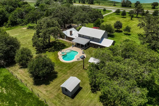 an aerial view of a house with yard swimming pool and outdoor seating