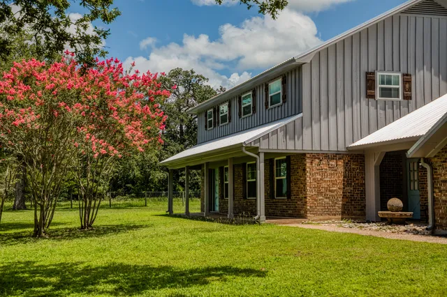 a front view of a house with a garden