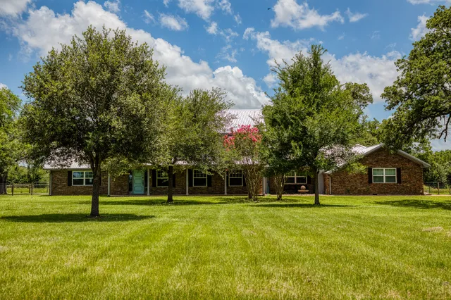 a house view with trees in the background