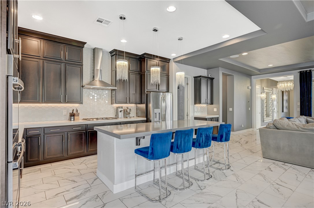3943 Reyes Avenue Las Vegas, NV 89141 - Photo 13 of 95 Gleaming tiled floors complement this kitchen's rich cabinetry and spacious island.