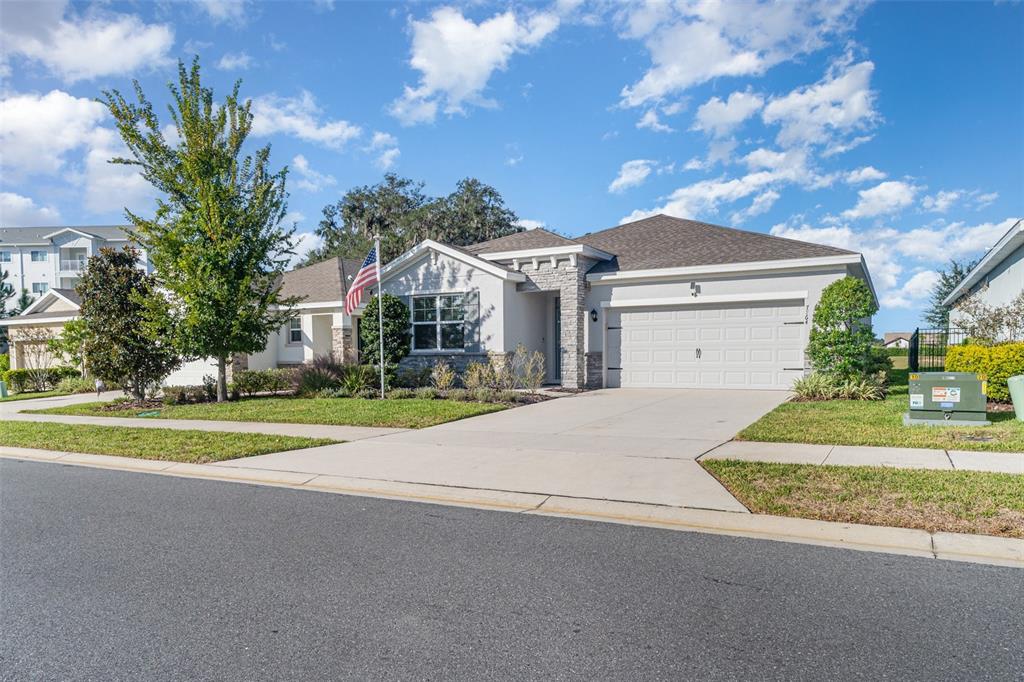 a front view of a house with a yard and garage