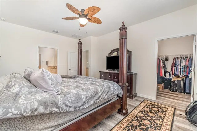 a bathroom with a granite countertop sink two mirror and a shower