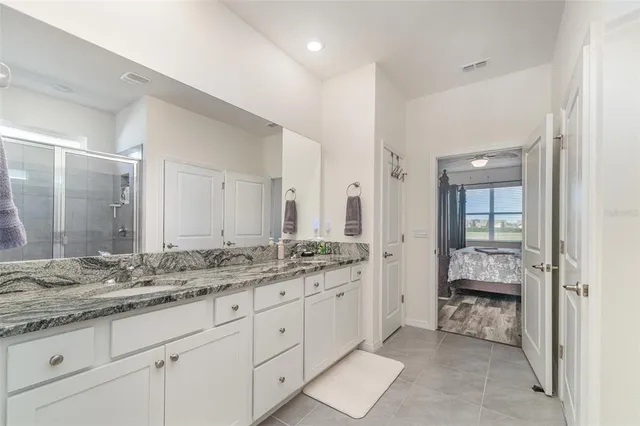 a bathroom with a glass shower door