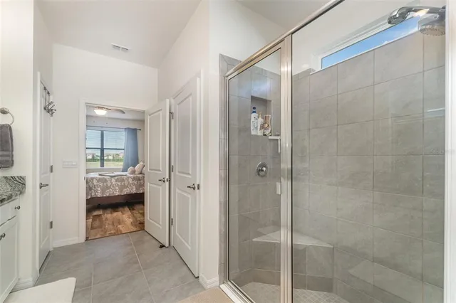 a bathroom with a granite countertop sink mirror vanity and toilet