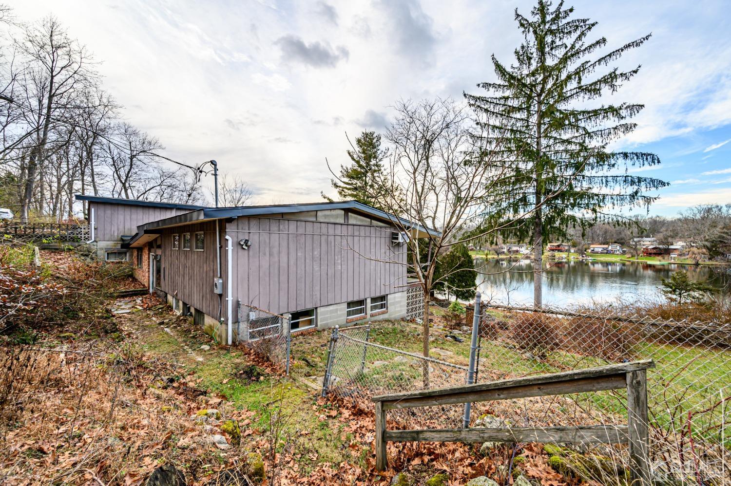 43 Shore Road Andover, NJ 07821 - Photo 12 of 25 a backyard of a house with lots of green space