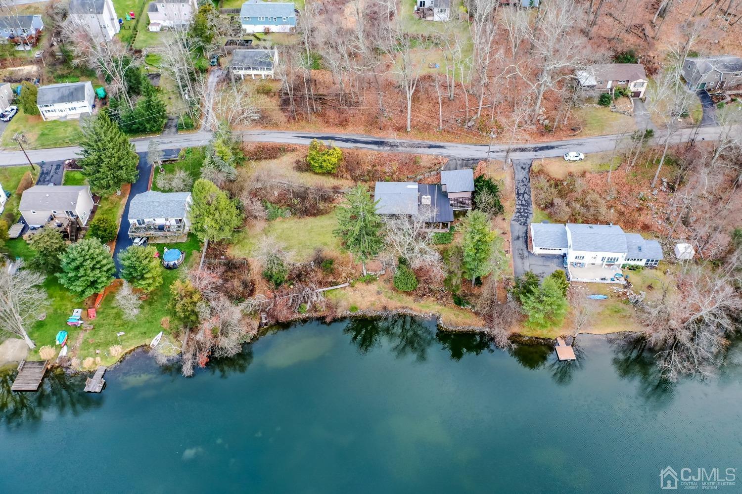 43 Shore Road Andover, NJ 07821 - Photo 14 of 25 a view of a lake with a building in front of it