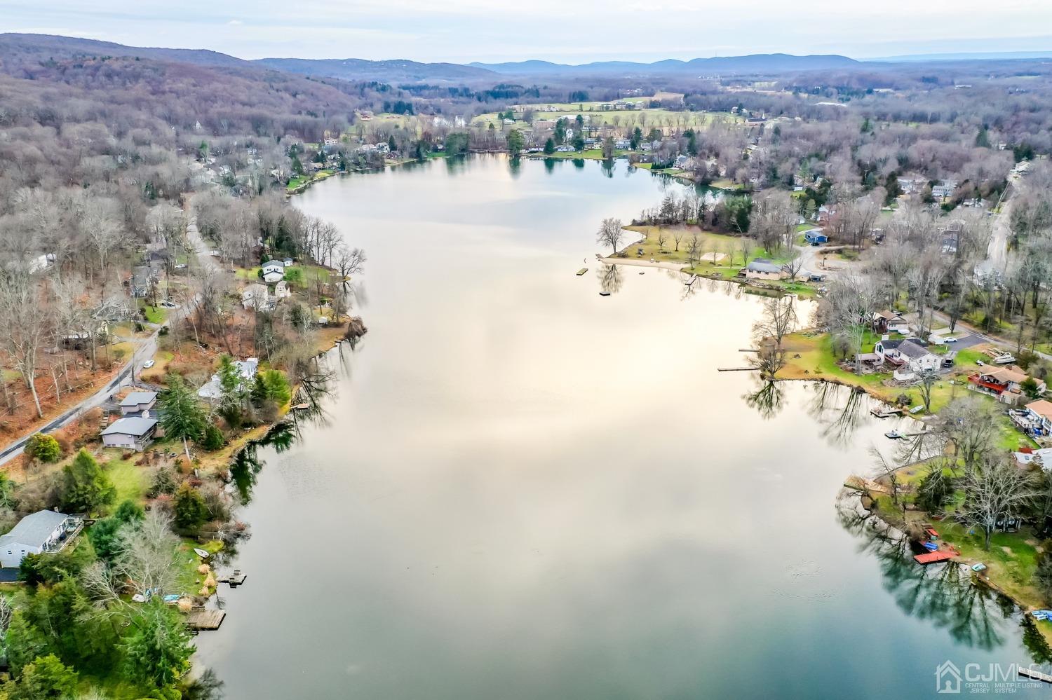 43 Shore Road Andover, NJ 07821 - Photo 16 of 25 a view of a lake with mountains in the background