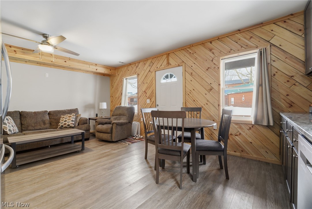 5919 Lake Road West, Unit 33 Ashtabula, OH 44004 - Photo 8 of 22 Dining room featuring a ceiling fan, wood finished floors, and wood walls