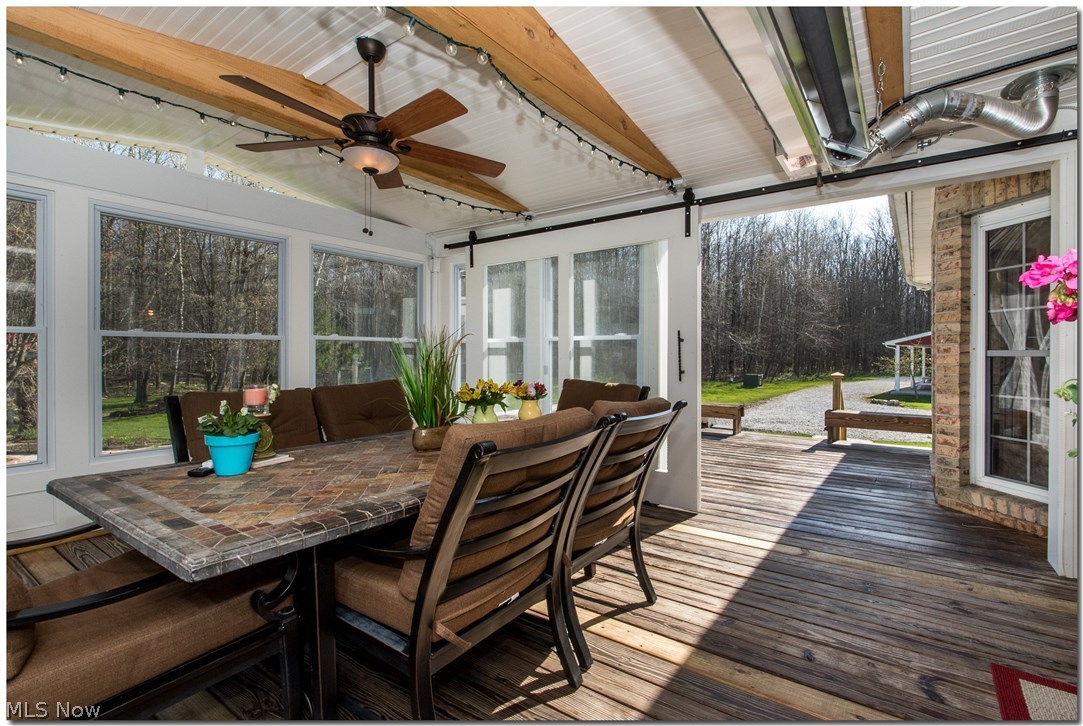 17580 Huntley Road Windsor, OH 44099 - Photo 17 of 35 Sundeck: 3 season enclosure .. all wrapped with Azek for low maintenance, barn doors made on site, commercial style infrared heater (runs on gas from on property gas well--free gas)