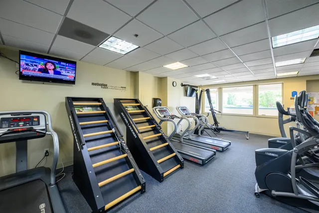 a room with gym equipment and a large window
