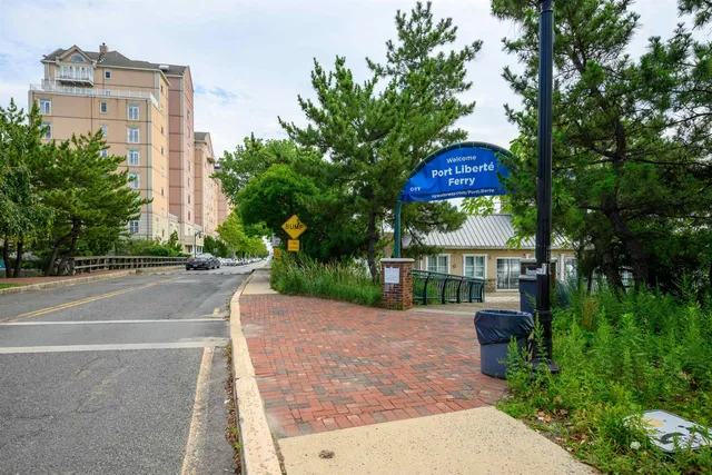 a view of a house with a yard and table and chairs under an umbrella