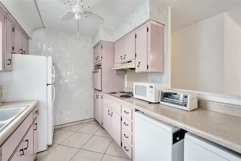 a kitchen with stainless steel appliances a sink stove and refrigerator