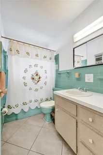 a bathroom with a sink toilet and mirror