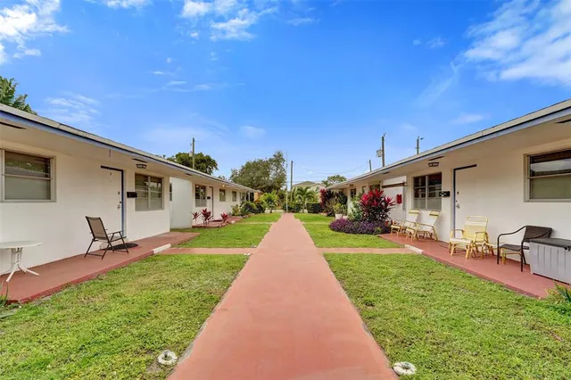 a front view of a house with a yard and trees