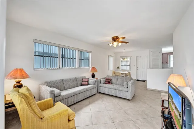 a living room with furniture a couch and a chandelier