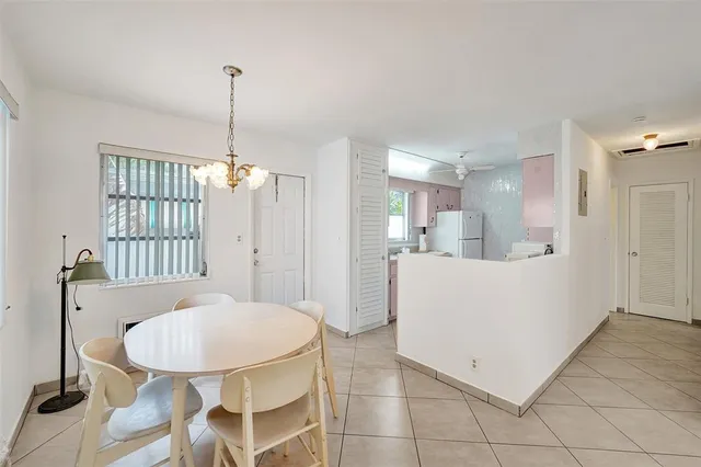 a view of a kitchen and a dining room with chandelier
