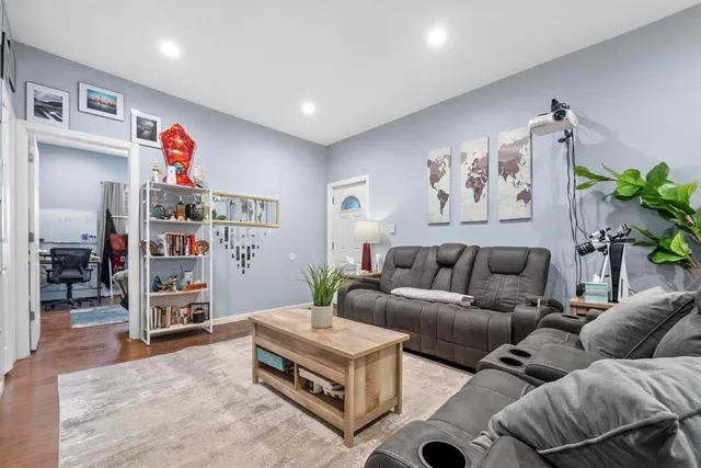 a living room with furniture and a bookshelf