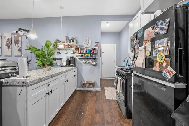 a kitchen with stainless steel appliances a sink stove and cabinets