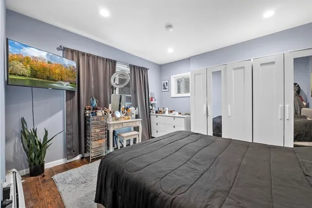 a bedroom with a large bed and potted plant