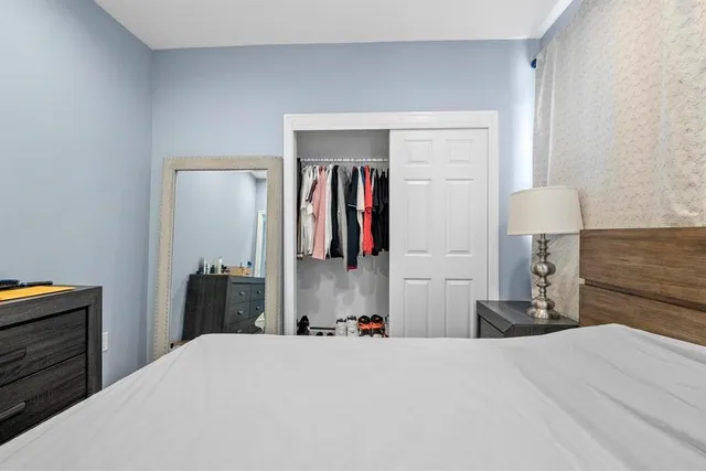 a bedroom with a bed and closet
