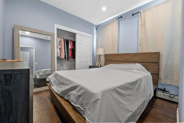 a bedroom with a bed and a mirror