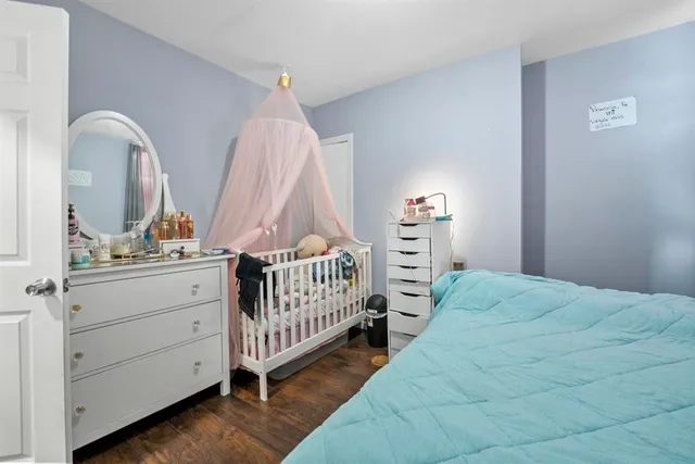 a view of bedroom with furniture and baby crib