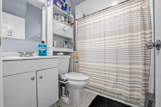 a bathroom with a sink toilet vanity and tub