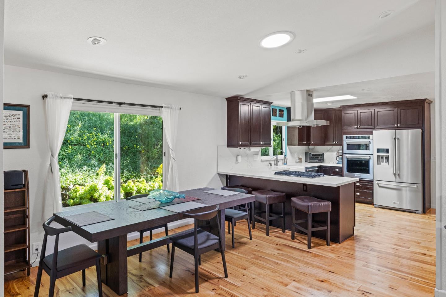 459 Echo Valley Road Salinas, CA 93907 - Photo 10 of 28 a kitchen with kitchen island a table and chairs in it
