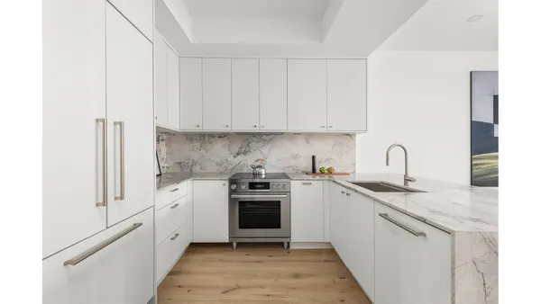 a kitchen with a sink chairs and cabinets