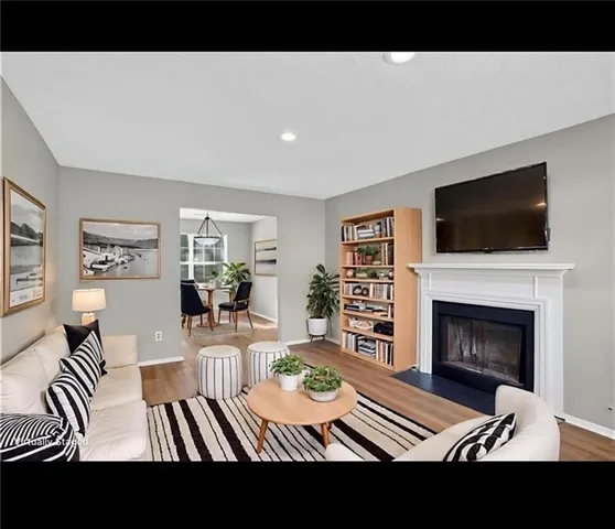 a view of living room with furniture and a fireplace