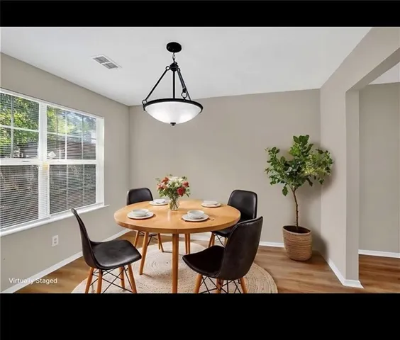 a view of a dining room with furniture and a potted plant