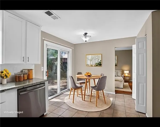 a dining room with furniture and window