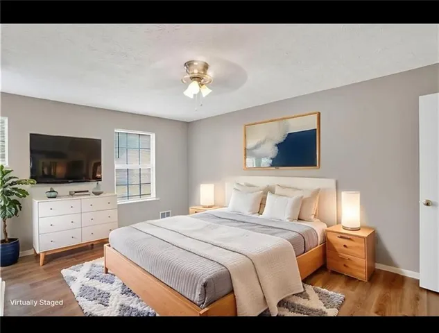 a bedroom with a large bed and a flat screen tv