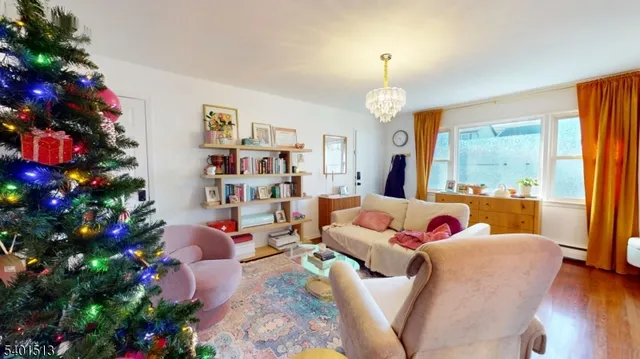 a living room with furniture and a flower garden