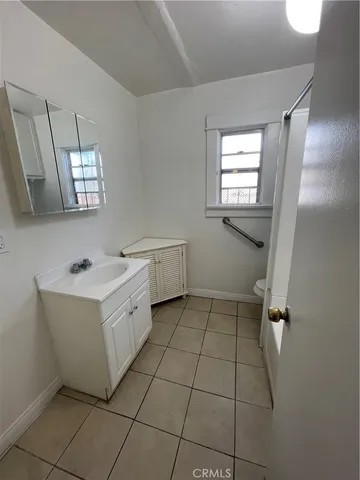 a bathroom with a bathtub sink and mirror