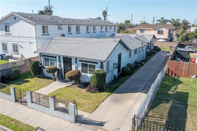 a view of a house with backyard porch and sitting area