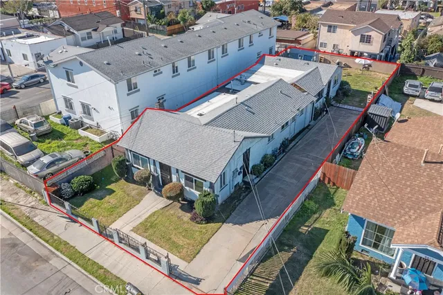 an aerial view of multiple houses with yard