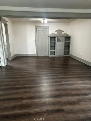 a view of room with wooden floor