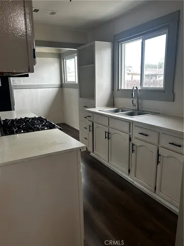 a kitchen with a sink stove and cabinets