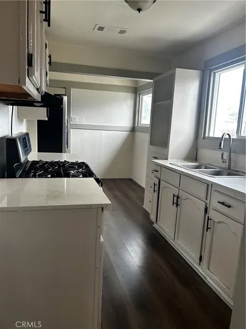 a kitchen with a sink and a refrigerator